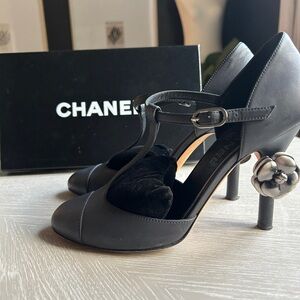 Chanel T Strap Mary Jane’s in black leather with camellia metal heel detail
